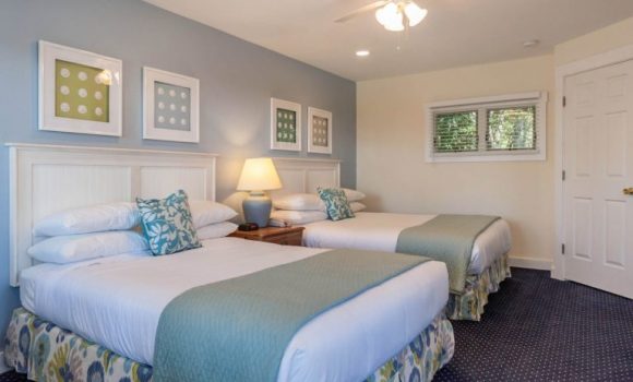A nicely appointed hotel room with two queen beds.